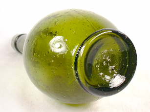 Glass tipped pontil scar on the base of a mid-19th century sauce bottle; click to enlarge.