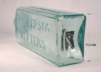 Rectangular iron pontil mark on the base of an 1850's bitters bottle from New York; click to enlarge.
