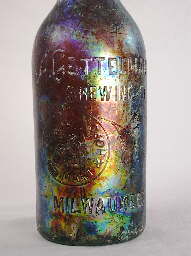 Early 20th century beer bottle with colorful patination; click to enlarge.