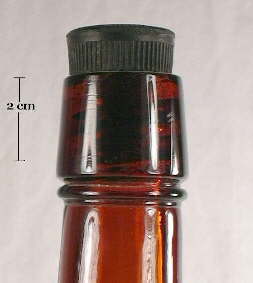 Image of a ca. 1900 liquor bottle with inside threads and a hard rubber stopper; click to enlarge.