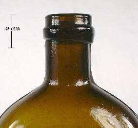 Image of a champagne style finish on a mid 19th century pictorial liquor flask; click to enlarge.
