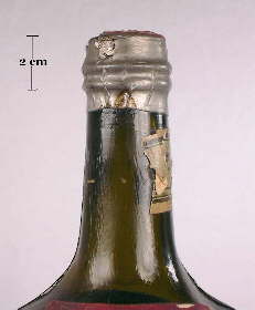 Foil seal over a cork on a Ferro-China medicinal tonic bottle; click to enlarge.