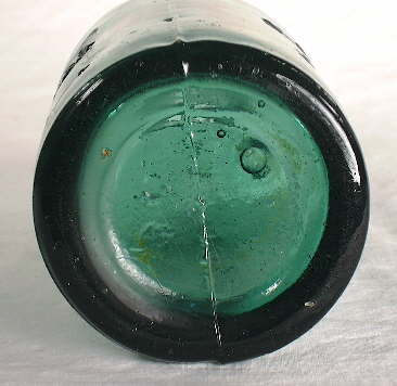 Two-piece mold base on an 1860s stout bottle; click to enlarge.