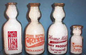 1940s and 1950s ACL cream top milk bottles; click to enlarge.