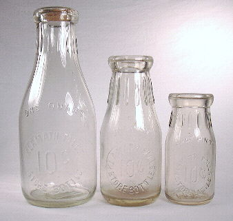1920s to 1940s era milk bottles; click to enlarge.