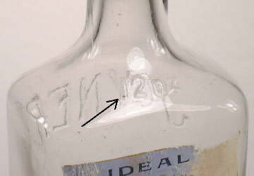 Late (1910s) mouth-blown bottle with capacity embossing; click to enlarge.