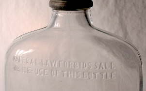 Mid-20th century liquor flask with the Federally required embossed statement.
