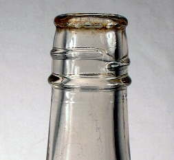 Image of a 1930's catsup bottle with a lower bead or string rim below the screw threads; click to enlarge.