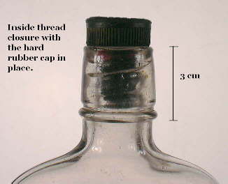 Image of an early 20th century liquor flask with a inside thread finish with a hard rubber stopper; click to enlarge.