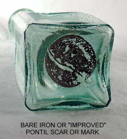 Bare iron or improved pontil scar on the base of a bottle. Click to view a larger version of the image.