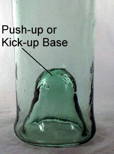 Close-up view of the push-up on the base of a mid-19th century French wine bottle; click to enlarge.