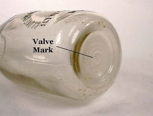 Close-up view of a valve mark on the base of an 1930's milk bottle from Nevada; click to enlarge.