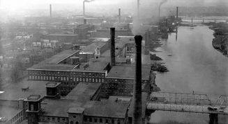 Aerial view of factories with smoke